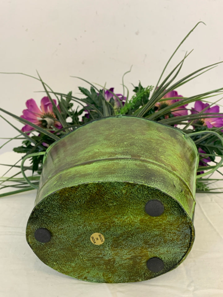 GREEN VASE W/PURPLE FAUX FLOWERS.