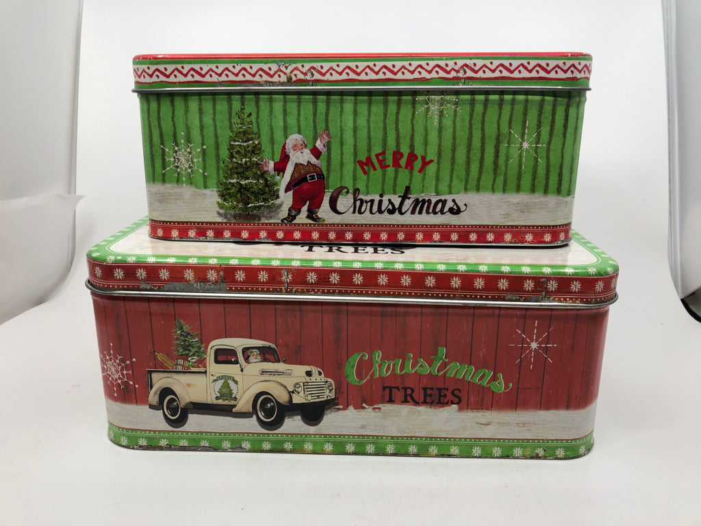 2 NESTING TINS W/ CREAM VINTAGE TRUCK W/ SANTA DRIVING.