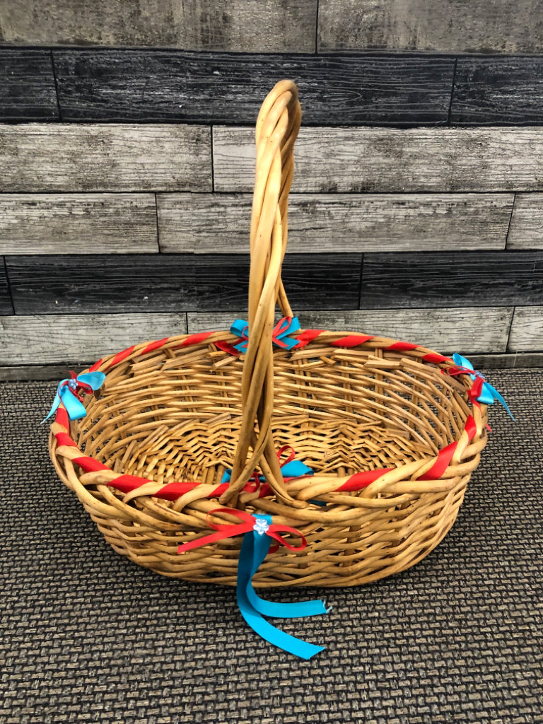 BLONDE WICKER BASKET W/BLUE AND RED BOWS.