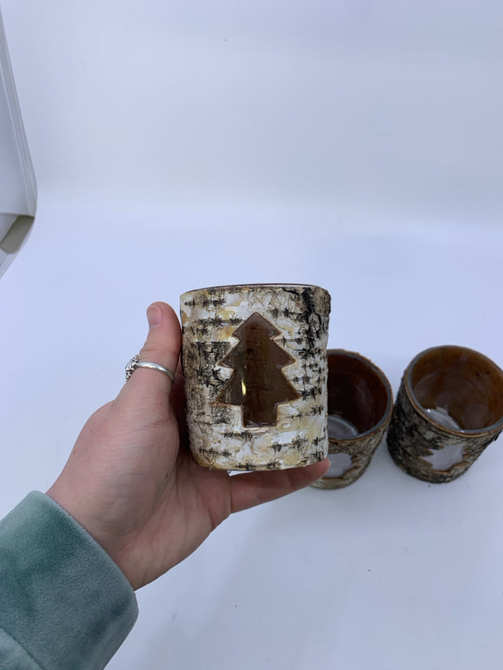 3 TREE BARK COVERED TEA LIGHT HOLDERS W/ TREE CUTOUT.