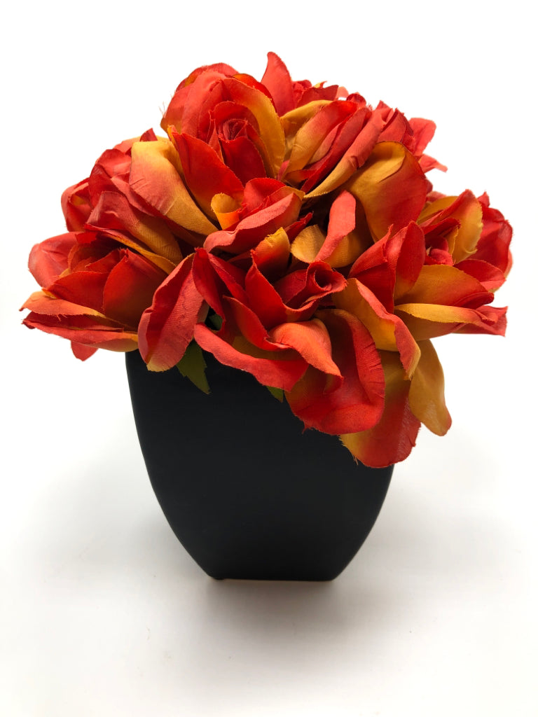 ORANGE FLOWERS IN BLACK POT.