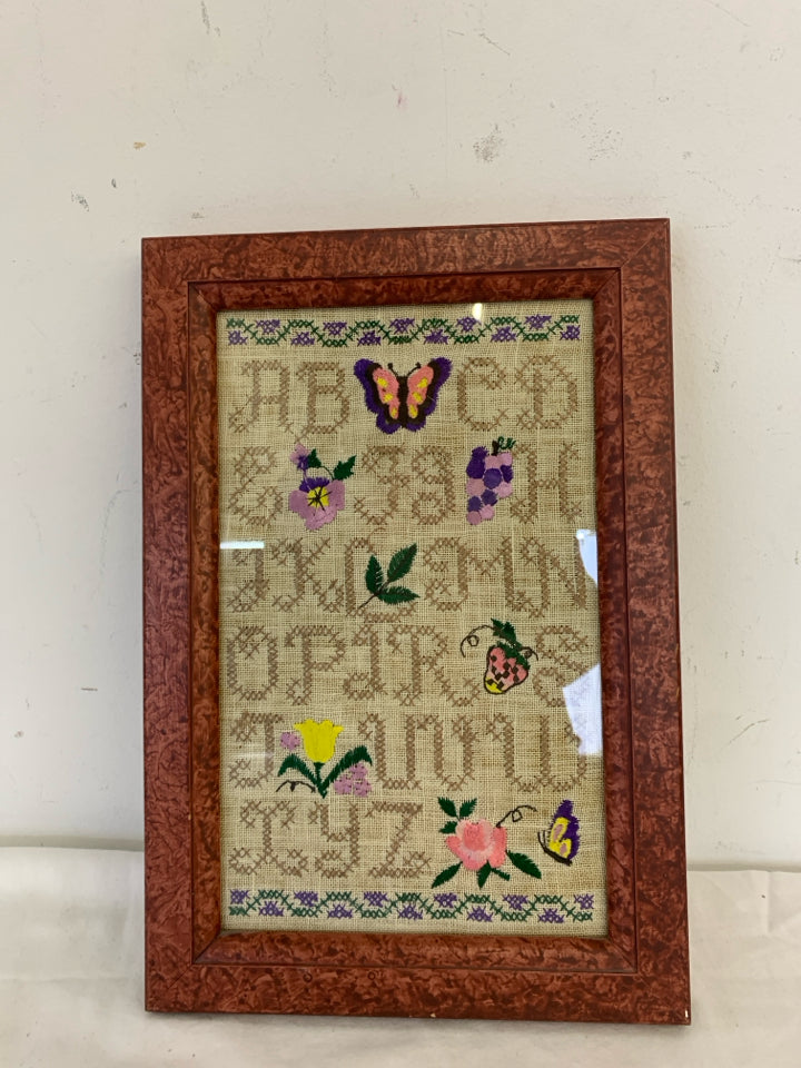 ABC'S NEEDLEPOINT SAMPLER IN RED FRAME WALL HANGING.