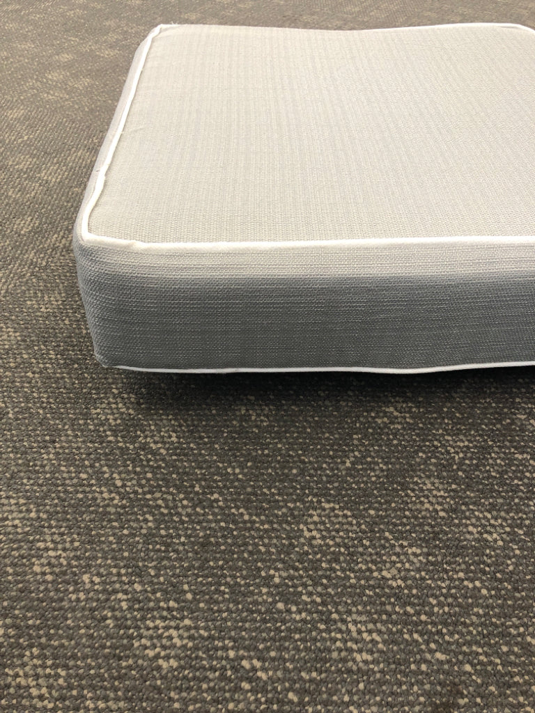 GRAY SEAT CUSHION W/WHITE TRIM.
