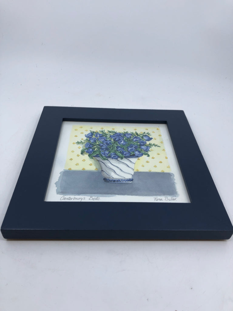 BLUE FLORAL IN YELLOW BACKGROUND IN BLUE FRAME WALL ART.