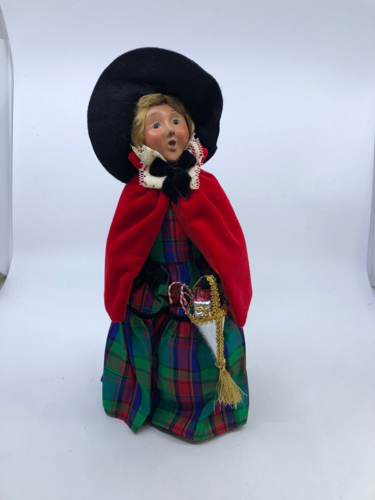 BYERS' CHOICE WOMAN IN RED COAT AND PLAID DRESS.