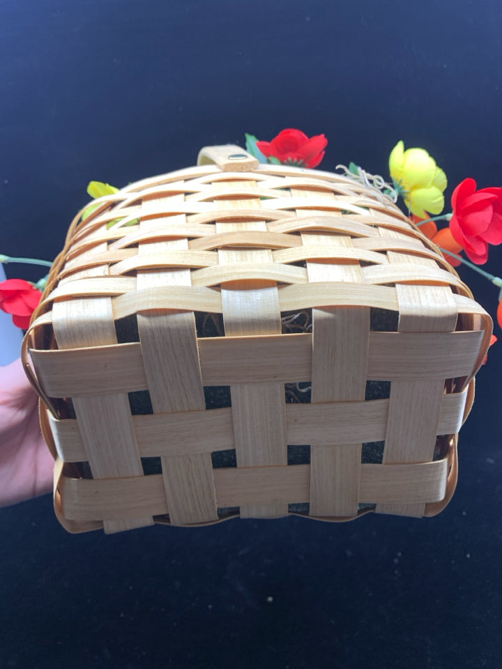 FAUX YELLOW AND PINK FLOWERS IN BASKET.