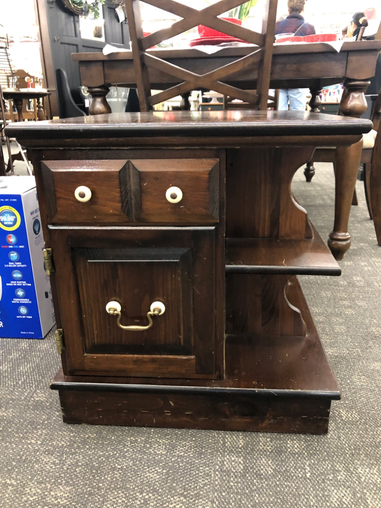 DARK WOOD SIDE TABLE WITH DRAWER/DOOR AND SHELVES.