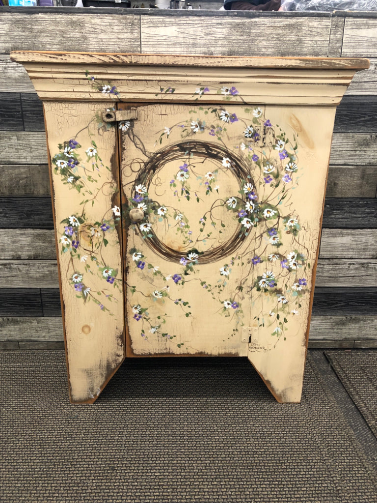 PRIMITIVE STYLE TAN CABINET- 2 SHELVES HAND PAINTED WREATH W/ PURPLE/WHITE FLOWE