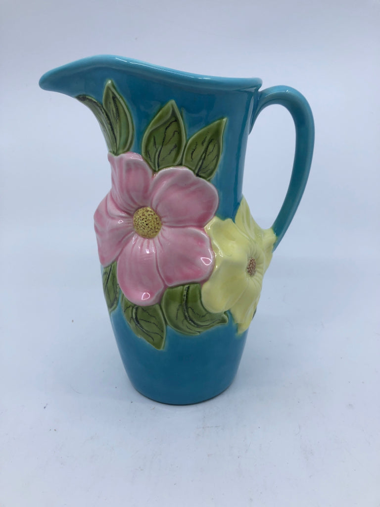 VTG BLUE POTTERY PITCHER W/ EMBOSSED PINK/YELLOW FLOWERS.