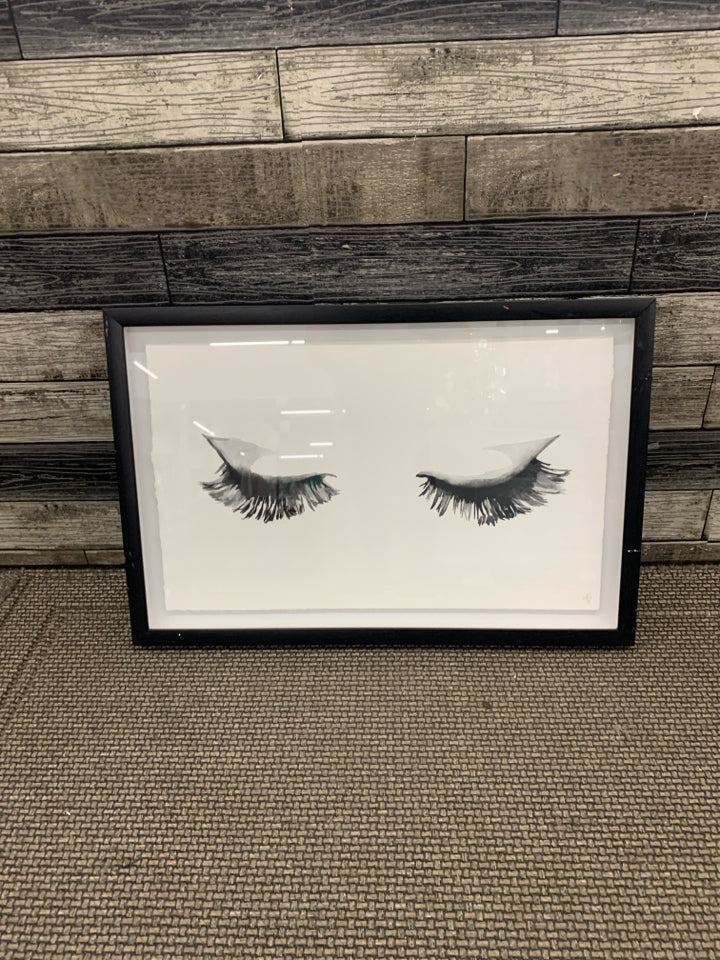 EYELASHES IN BLACK FRAME WALL HANGING.