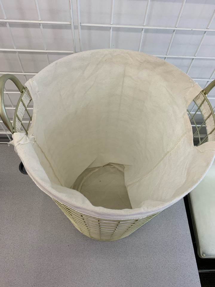 GOLD HAMPER W/ WHITE FABRIC LINER.