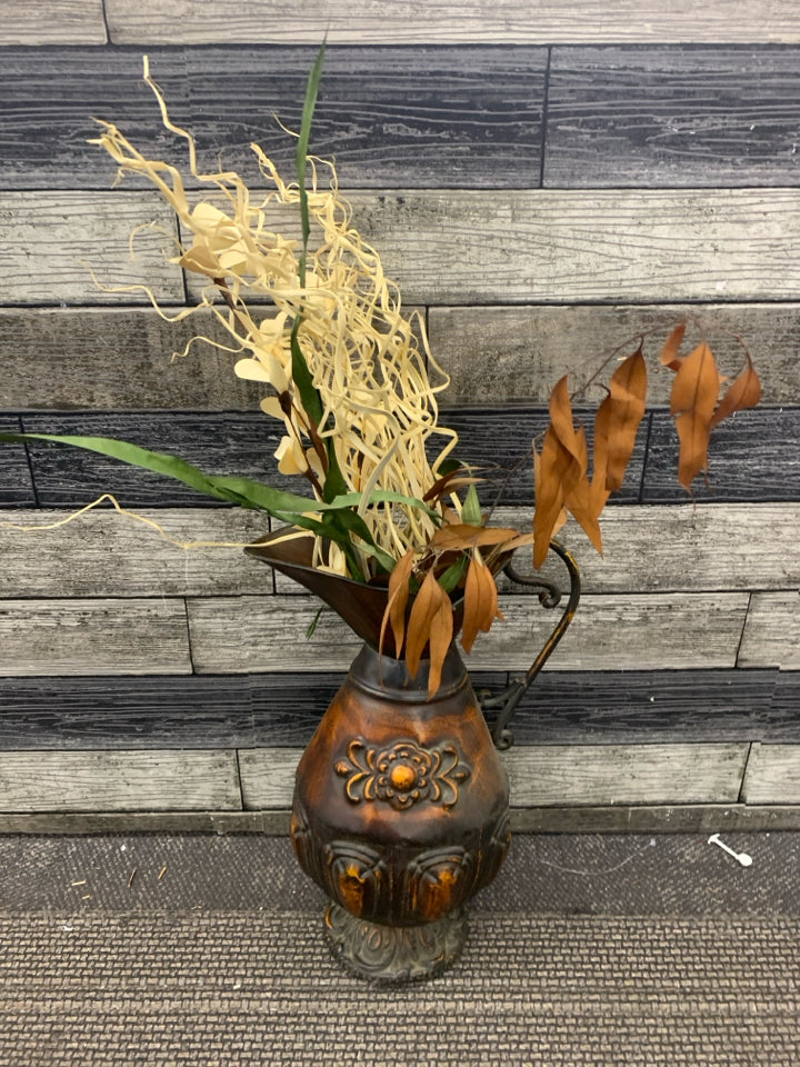 LARGE DISTRESSED METAL PITCHER W FAUX LEAVES.