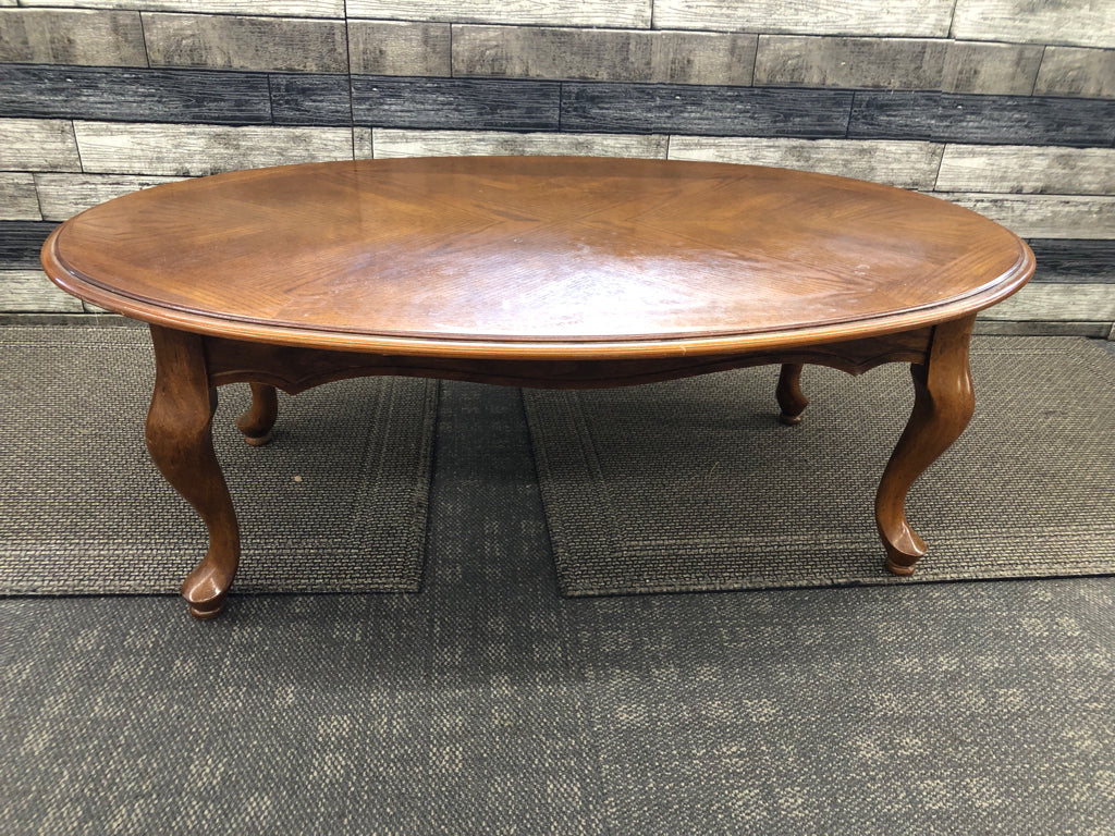 DARK WOOD OVAL COFFEE TABLE.