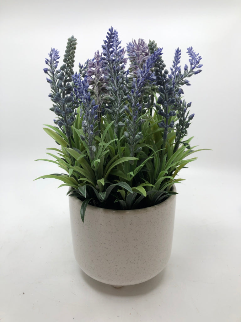 FAUX LAVENDER IN SPECKLED WHITE POT.
