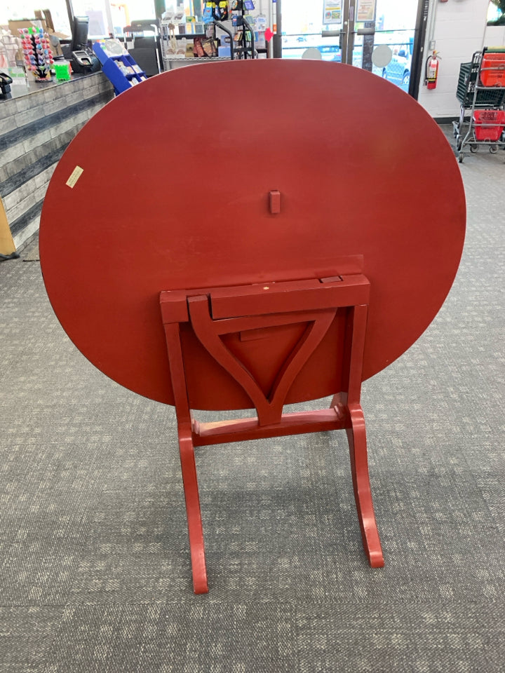 OVAL RED FLIP TOP TABLE.