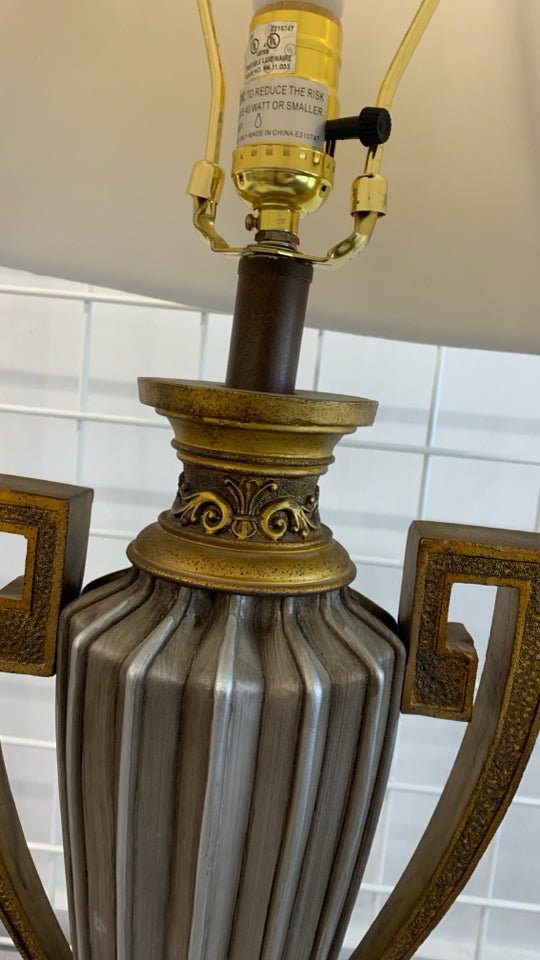 GOLDEN URN SHAPED LAMP W/TAN SHADE.