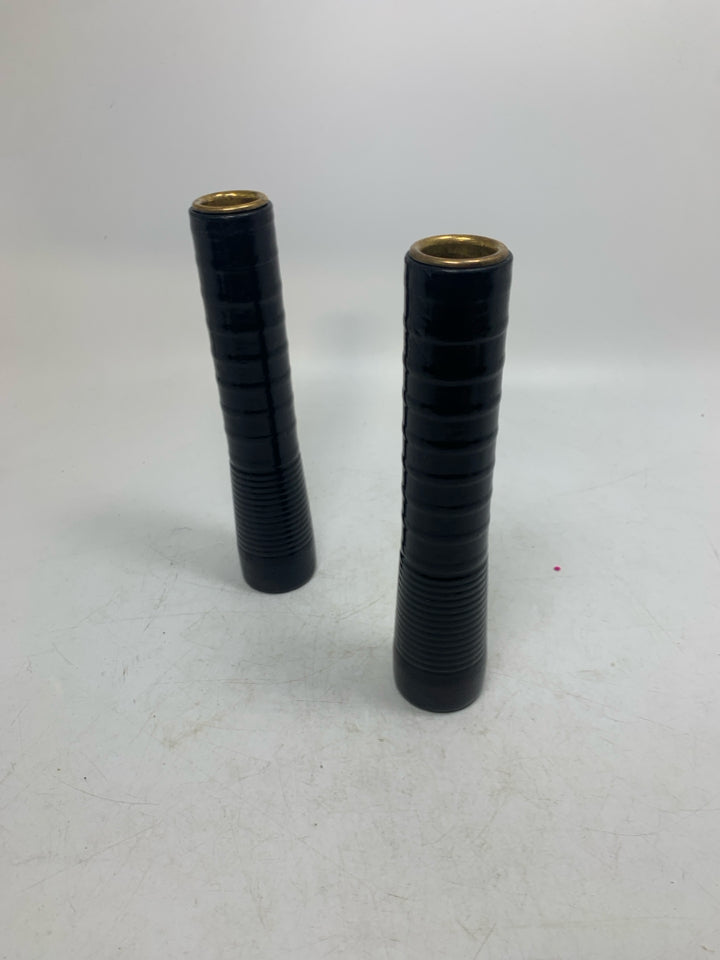 2 BLACK TAPERED CANDLE HOLDERS .