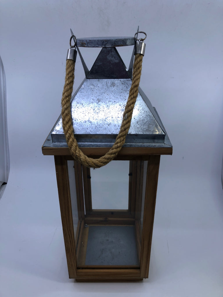 SILVER METAL AND BLONDE WOOD LANTERN ROPE HANDLE.