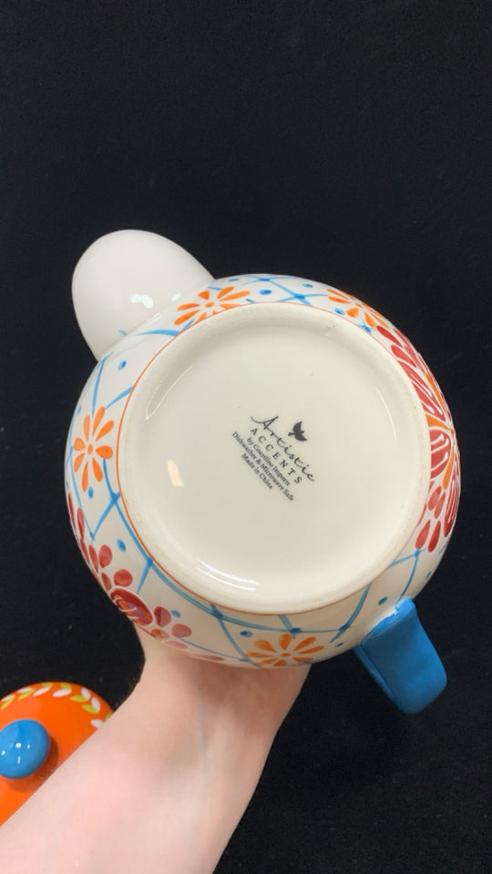 COLORFUL FLORAL TEAPOT W/BLUE HANDLE.