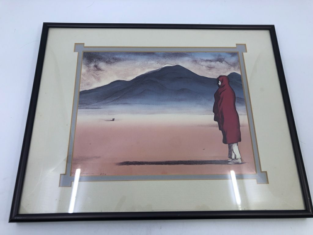 LADY WEARING RED IN DESSERT IN BLACK FRAME.