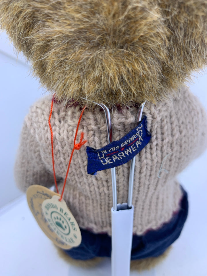 LIGHT BROWN BEAR W/ BEIGE SWEATER BLUE PANTS ON STAND.