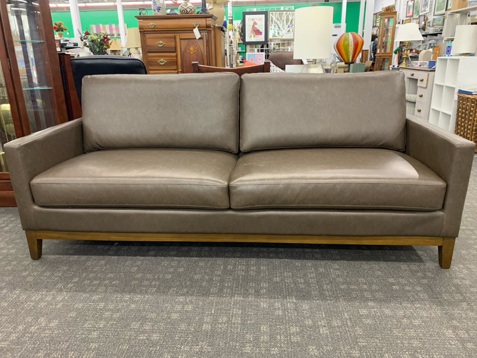 BROWN FAUX LEATHER COUCH.