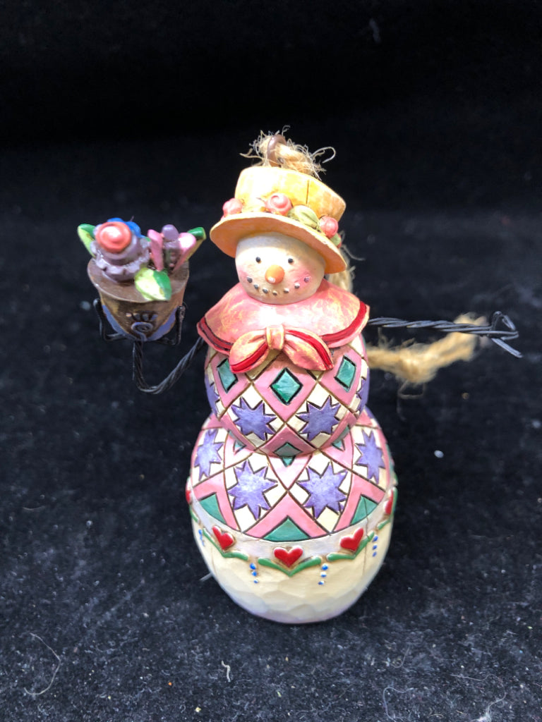 JIM SHORE HOLDING FLOWERS SNOW WOMAN.