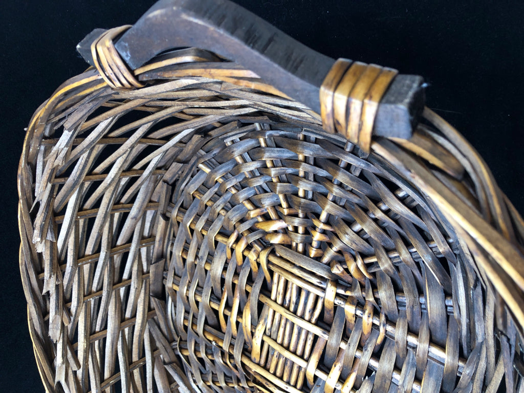 BROWN OVAL BASKET W/HANDLES.