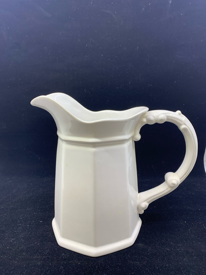 WHITE CERAMIC PITCHER W/DECORATIVE HANDLE.