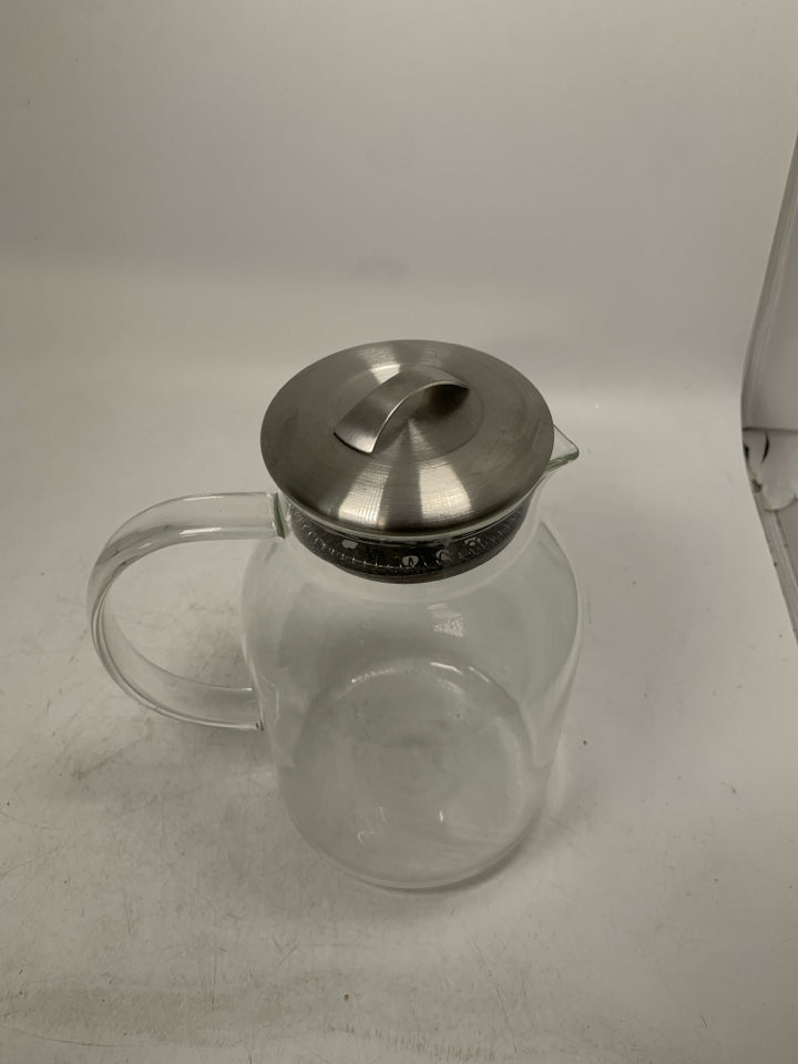 CLEAR GLASS PITCHER W/ METAL TOP.