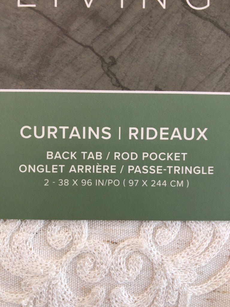 NIP 2PK CREAM BACK TAB CURTAINS.