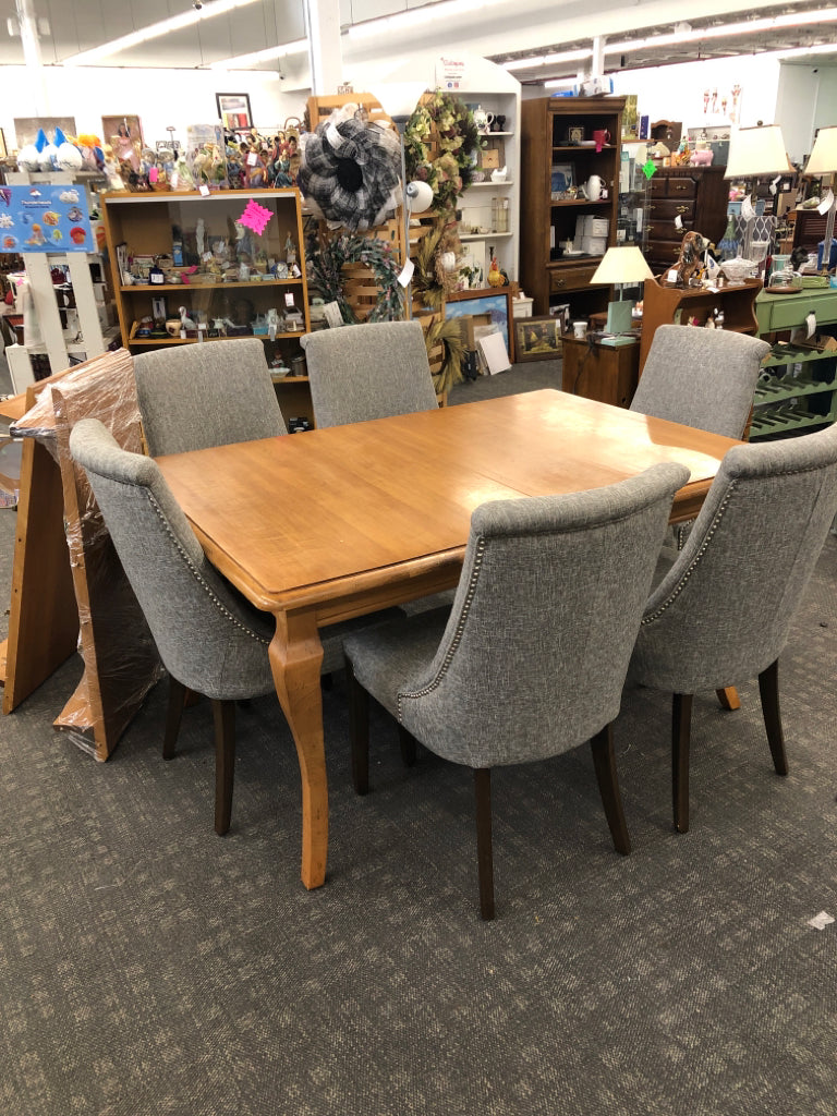 HEAVY WOOD TABLE W 2 LEAVES AND 6 GREY STUDDED CHAIRS.
