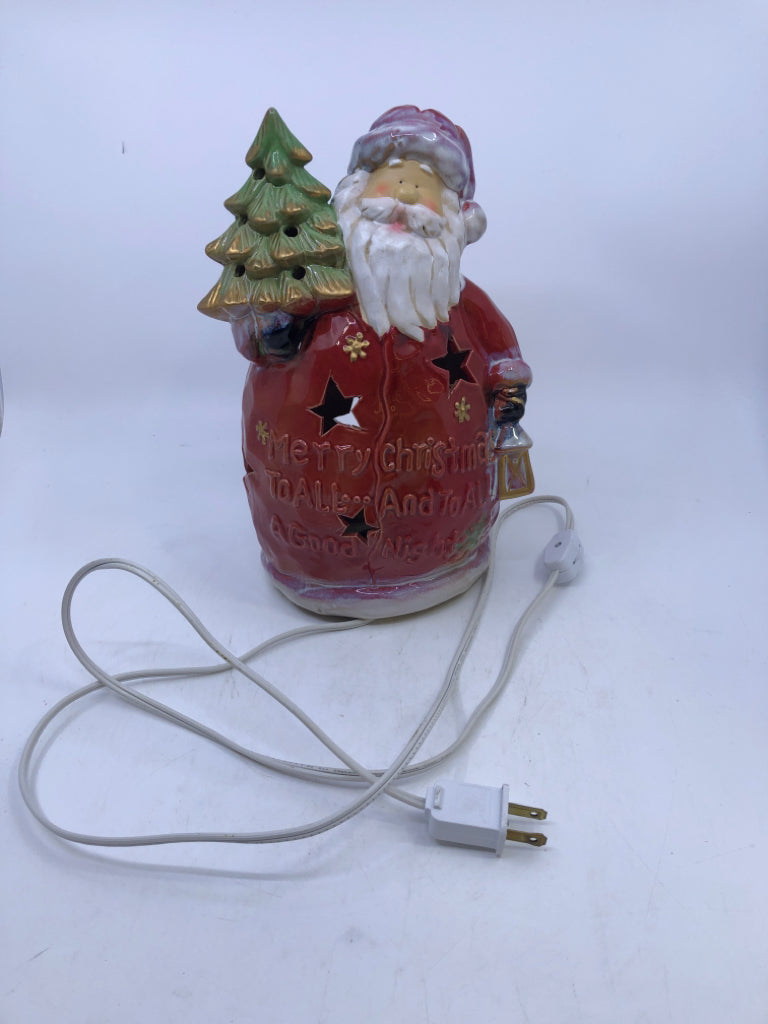 RED CERAMIC LIGHT UP SANTA HOLDING A TREE.