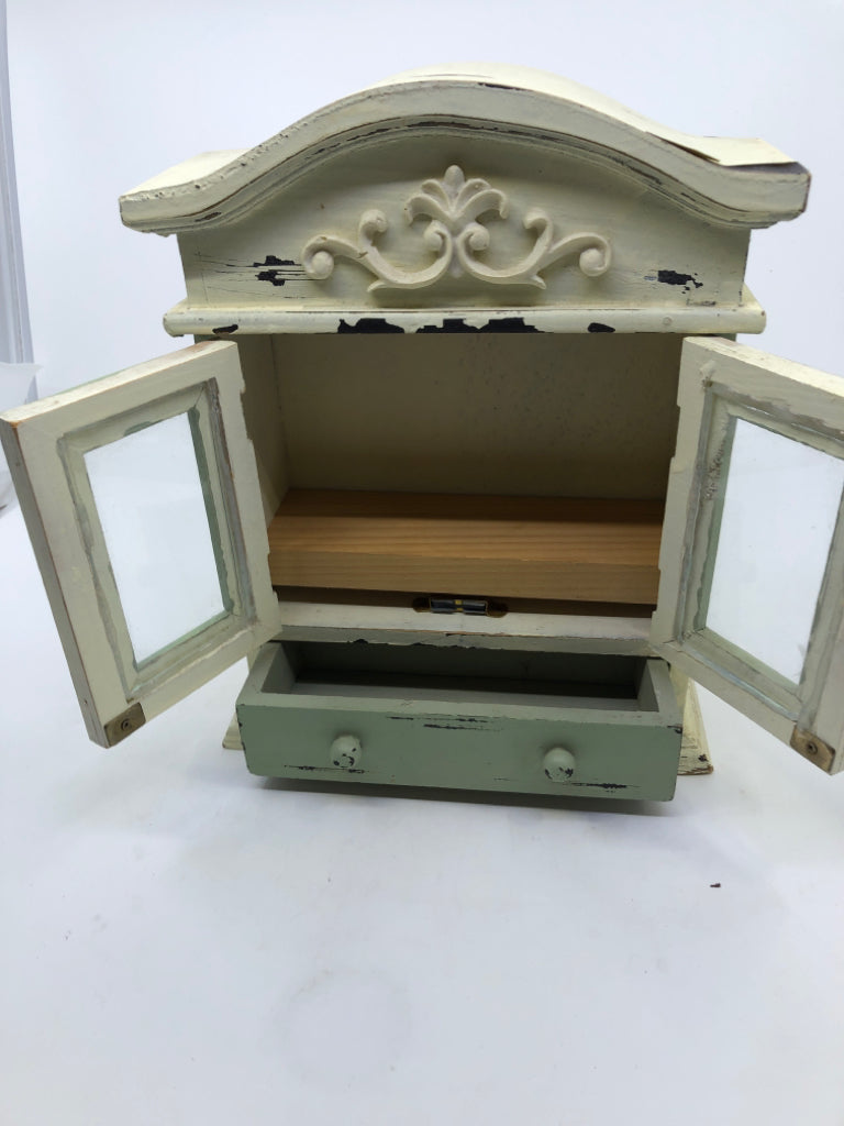 SMALL DISTRESSED PAINTED CABINET MINT GREEN+WHITE W/ SCROLL DESIGN.