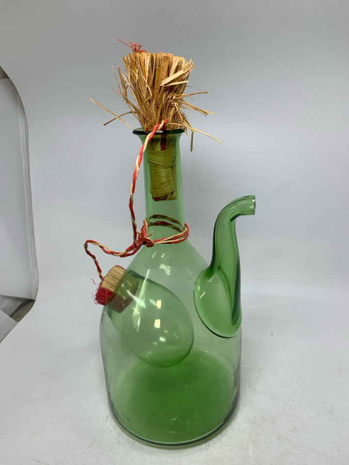 GREEN GLASS 2 COMPARTMENT DECANTER W/ WOVEN STOPPER.
