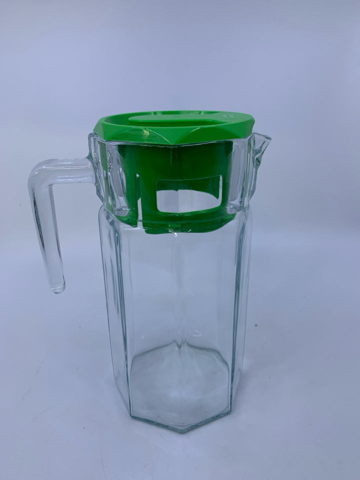 CLEAR GLASS PITCHER W/ GREEN PLASTIC TOP.