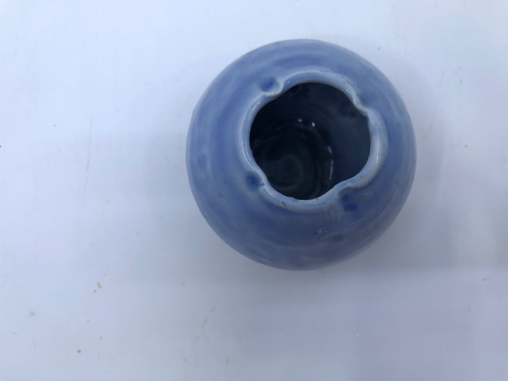SHORT LIGHT BLUE VASE W/ BLACK LINES ON BOTTOM.