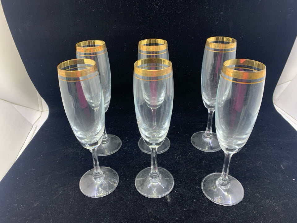 6 GOLD RIMMED CHAMPAGNE FLUTES.