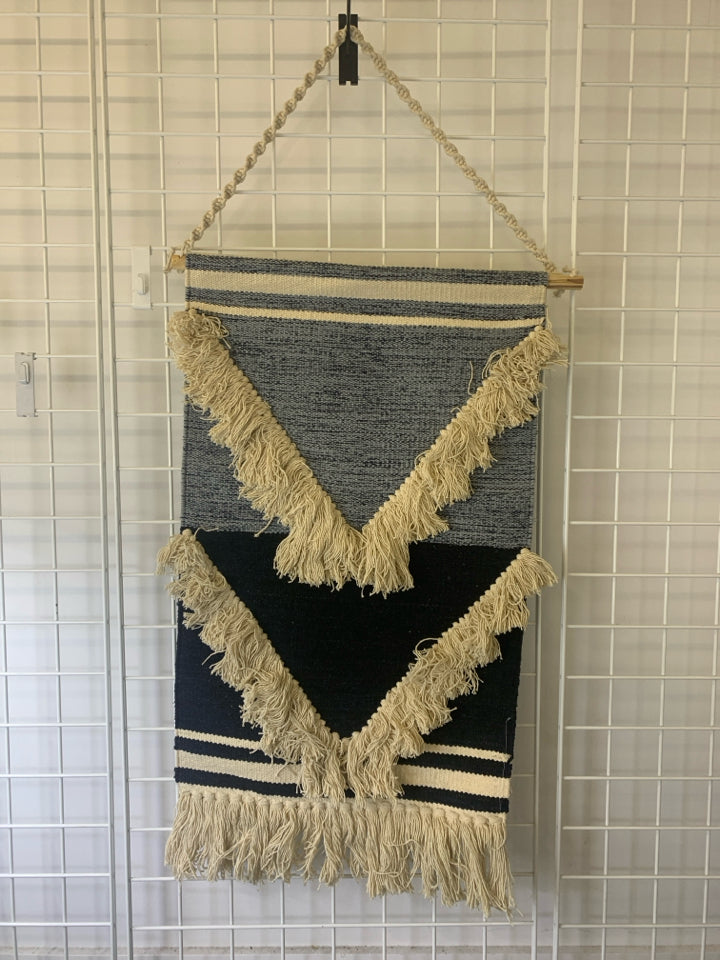 BLUE AND CREAM FABRIC WALL HANGING.