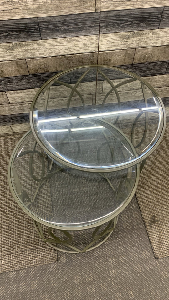 2PC ROUND GLASS STACKING TABLES W/METAL LEGS.