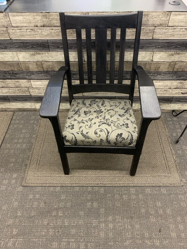 BLACK WOOD CHAIR W/ GREY BLACK LEAF DESIGN CUSHION.