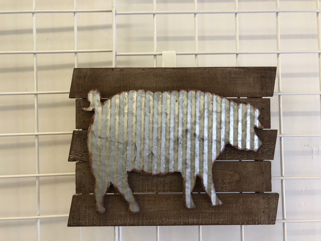 GALVANIZED METAL PIG ON WOOD SLATS.