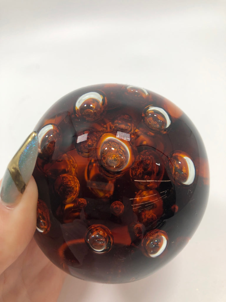 SM AMBER GLASS BUBBLE PAPER WEIGHT.
