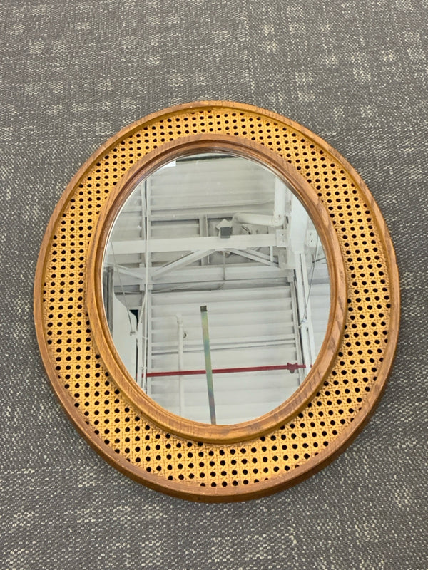 WOOD AND RESIN WICKER OVAL MIRROR.