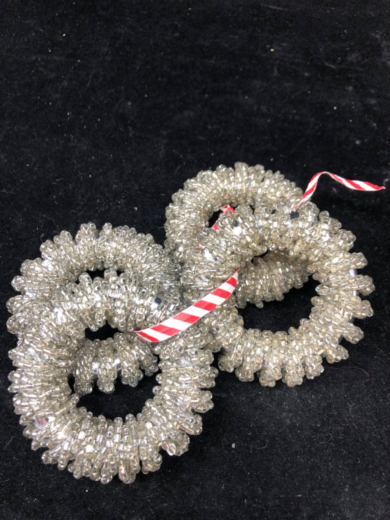 4 SILVER NAPKIN RINGS.