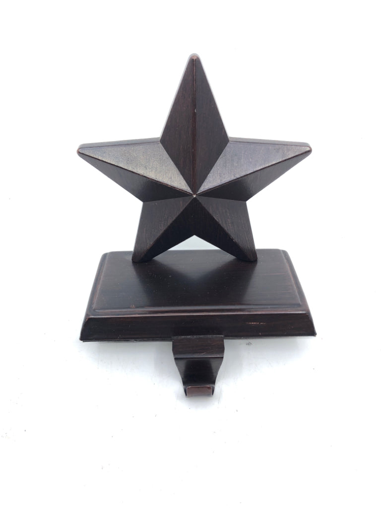 BROWN METAL STAR STOCKING HOLDER.