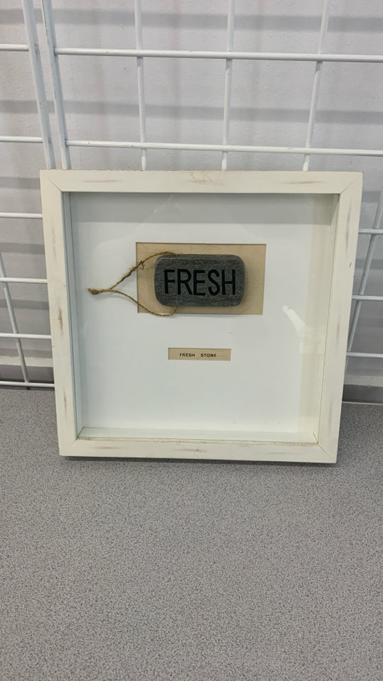 FRESH STONE IN WHITE WOOD FRAME.