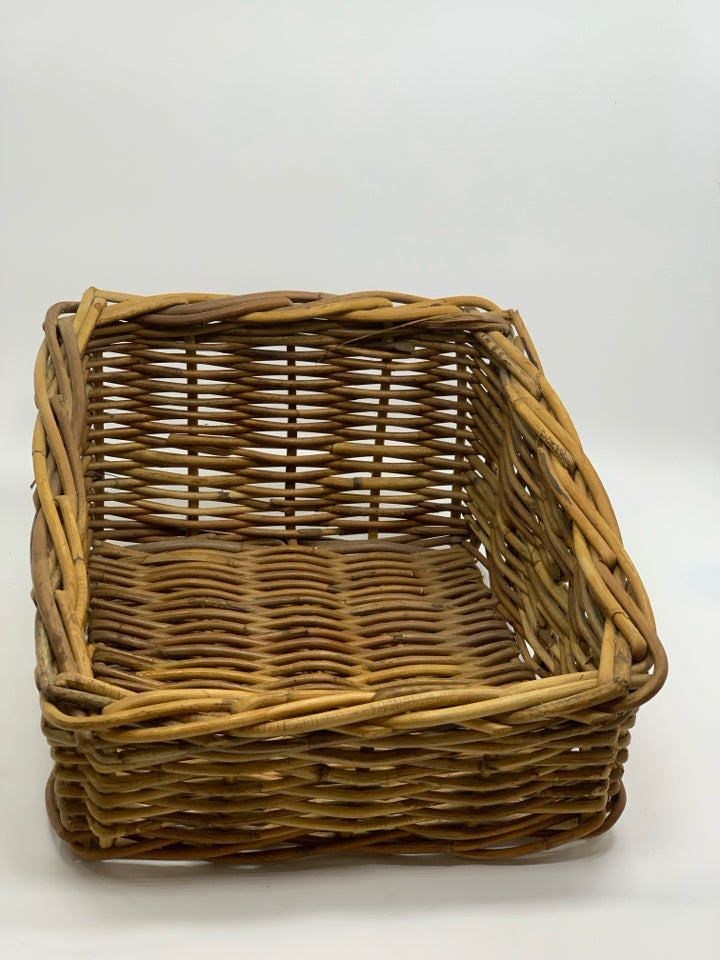 SLANTED BROWN WICKER BASKET.
