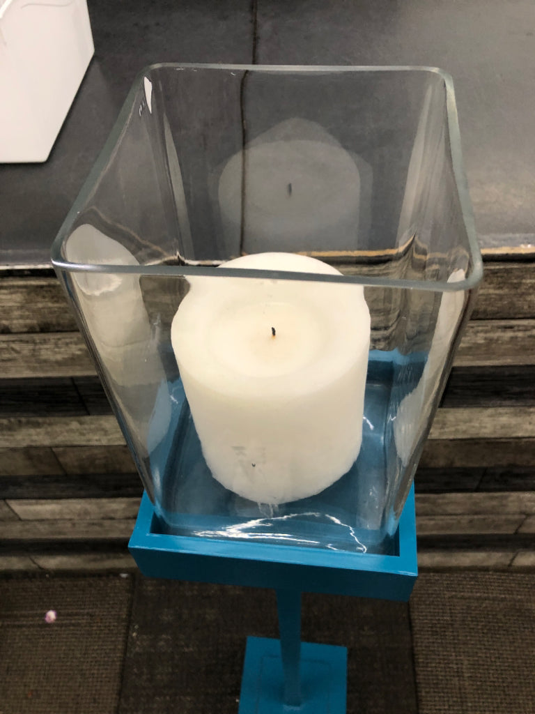 TALL BLUE SQUARE BASE CANDLE HOLDER W/CLEAR GLASS TOP.
