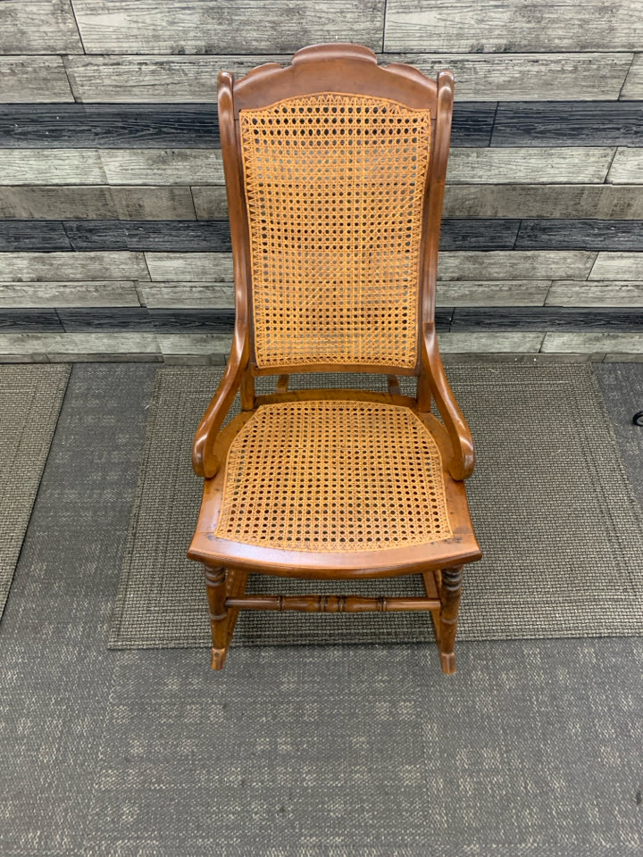 VINTAGE DARK BROWN CANE SEAT ROCKER.